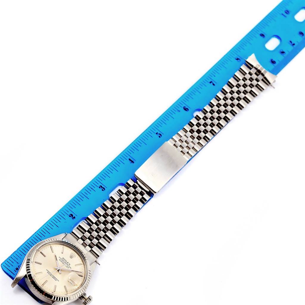 The image shows a Vintage Collection Rolex watch from a top-down angle, featuring its face, bezel, and bracelet alongside a ruler.