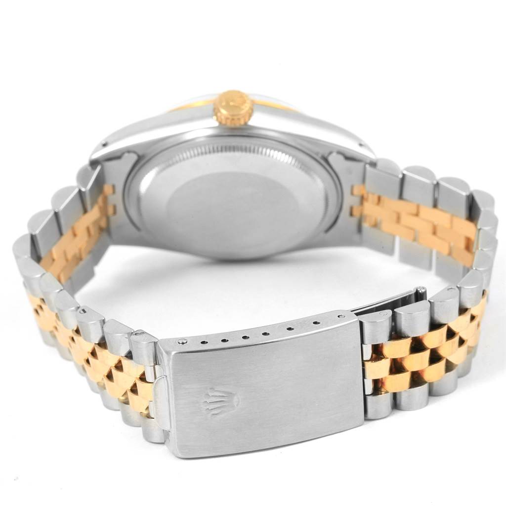 This is a rear view of a Rolex Vintage Collection ROLEX DATEJUST STEEL YELLOW GOLD TAPESTRY DIAL VINTAGE MENS WATCH 16013 Men's Stainless Steel Silver Dial ROLEX DATEJUST STEEL YELLOW GOLD TAPESTRY DIAL VINTAGE MENS WATCH 16013 Men's Stainless Steel Silver Dial watch showcasing its two-tone bracelet and closed clasp.