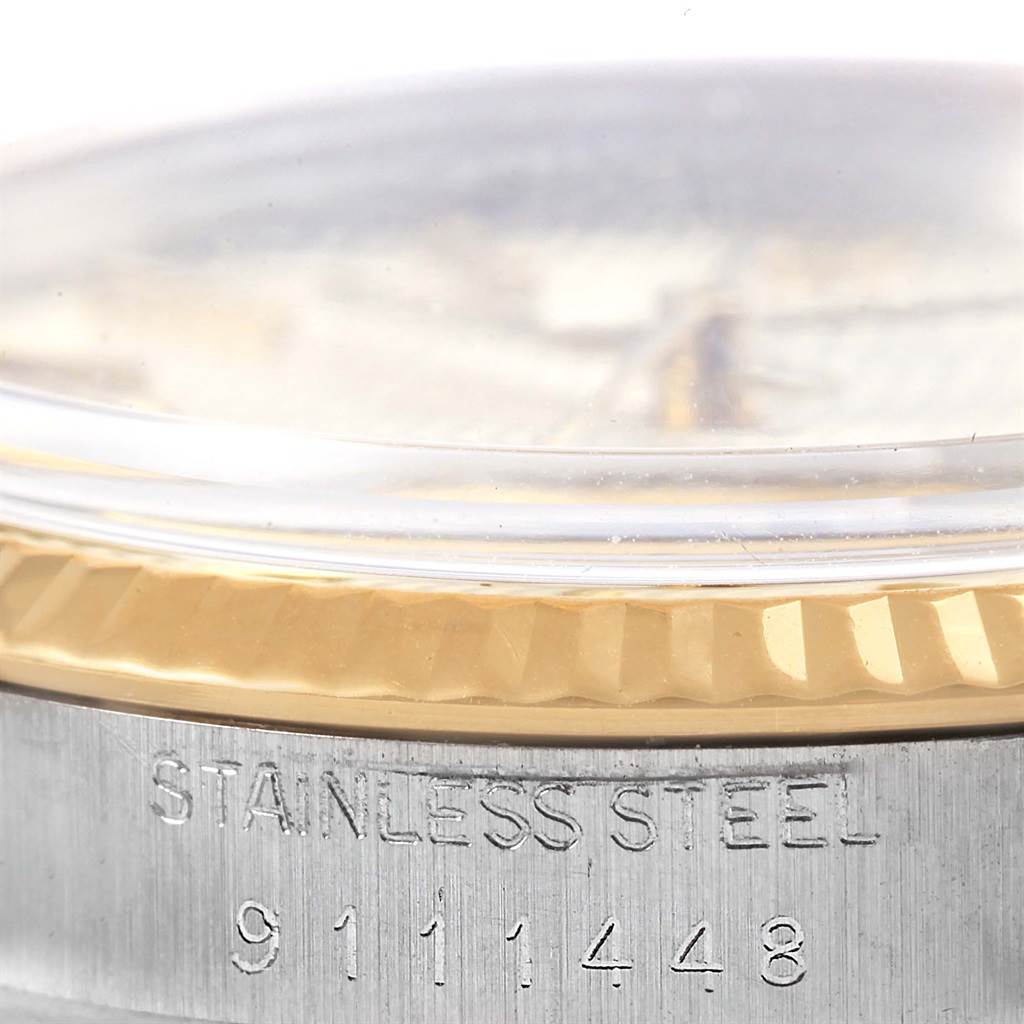 This image shows a close-up of the side of a Rolex Vintage Collection ROLEX DATEJUST STEEL YELLOW GOLD TAPESTRY DIAL VINTAGE MENS WATCH 16013 Men's Stainless Steel Silver Dial ROLEX DATEJUST STEEL YELLOW GOLD TAPESTRY DIAL VINTAGE MENS WATCH 16013 Men's Stainless Steel Silver Dial watch, highlighting the stainless steel case and serial number.