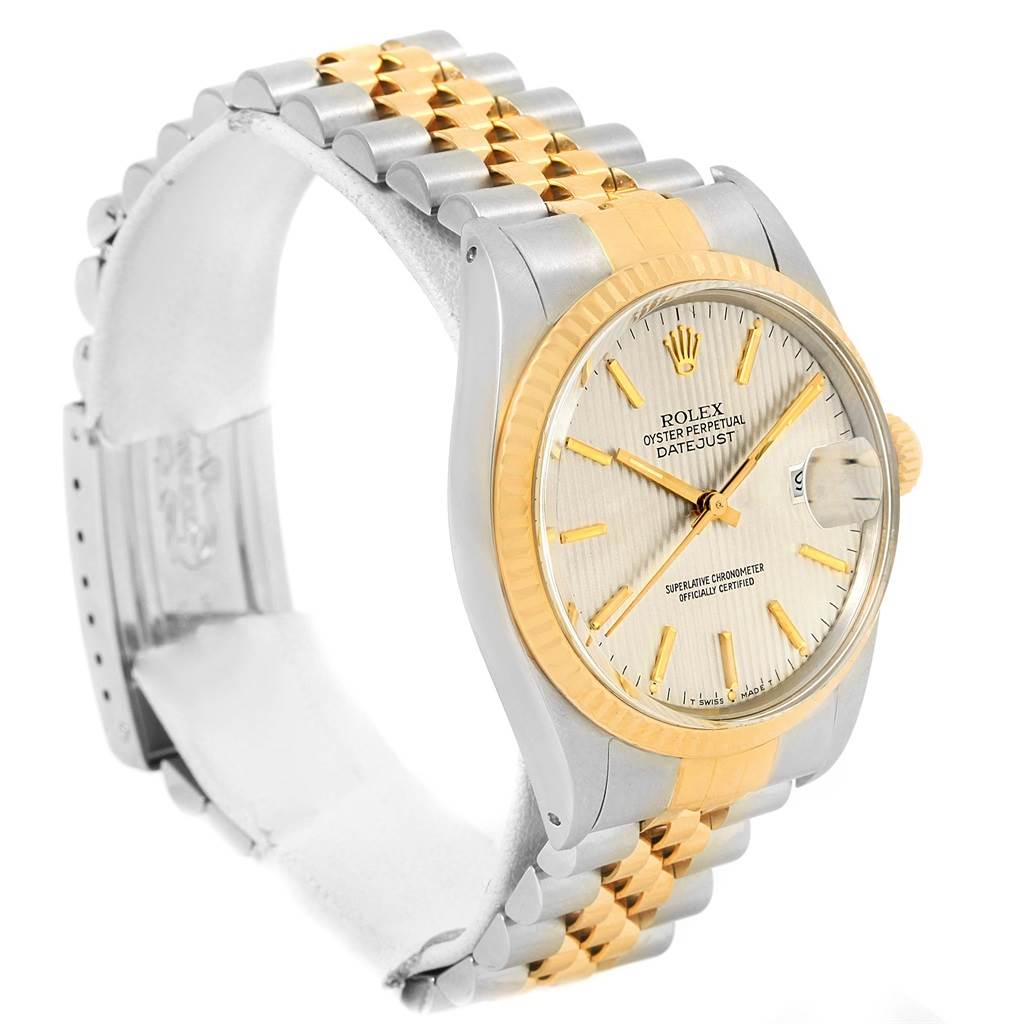 The Rolex Vintage Collection ROLEX DATEJUST STEEL YELLOW GOLD TAPESTRY DIAL VINTAGE MENS WATCH 16013 Men's Stainless Steel Silver Dial ROLEX DATEJUST STEEL YELLOW GOLD TAPESTRY DIAL VINTAGE MENS WATCH 16013 Men's Stainless Steel Silver Dial watch is shown from an angled front view, highlighting the watch face, bezel, and two-tone bracelet.