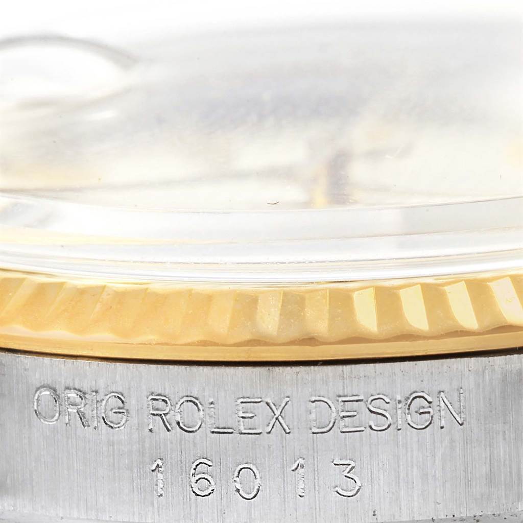 The image shows a close-up of the bezel and case of a Rolex Vintage Collection ROLEX DATEJUST STEEL YELLOW GOLD TAPESTRY DIAL VINTAGE MENS WATCH 16013 Men's Stainless Steel Silver Dial ROLEX DATEJUST STEEL YELLOW GOLD TAPESTRY DIAL VINTAGE MENS WATCH 16013 Men's Stainless Steel Silver Dial model, displaying "ORIG ROLEX DESIGN 16013."
