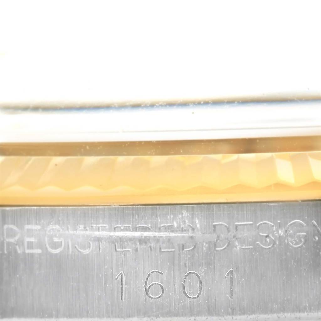 This close-up image shows the model engraving (1601) and a portion of the bezel of a Vintage Collection Rolex watch.
