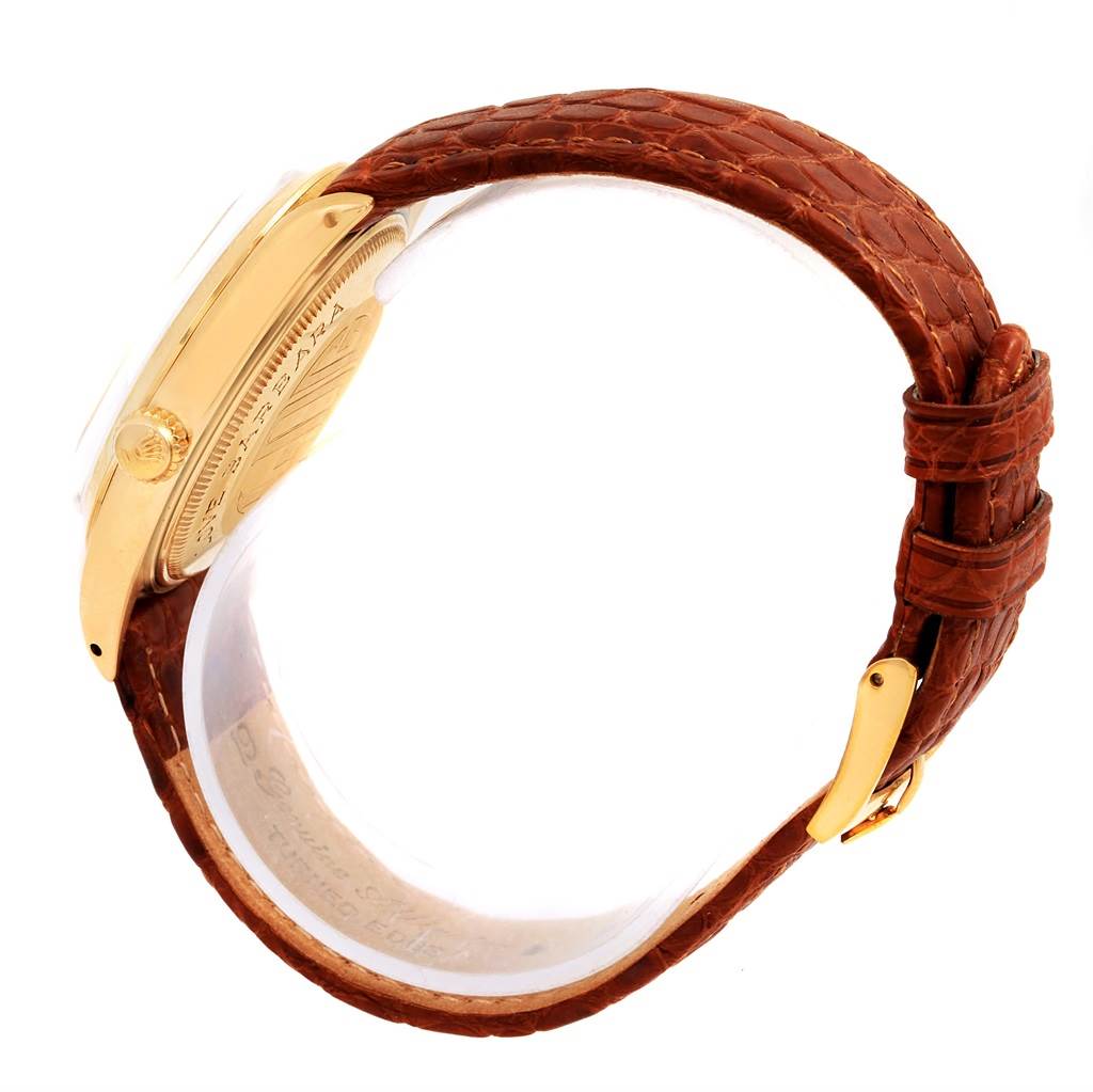 The Rolex Vintage Collection 1500 Men's Yellow Gold Champagne Dial 1500 Men's Yellow Gold Champagne Dial model watch is shown from a side angle, highlighting its gold casing, crown, and brown leather strap.