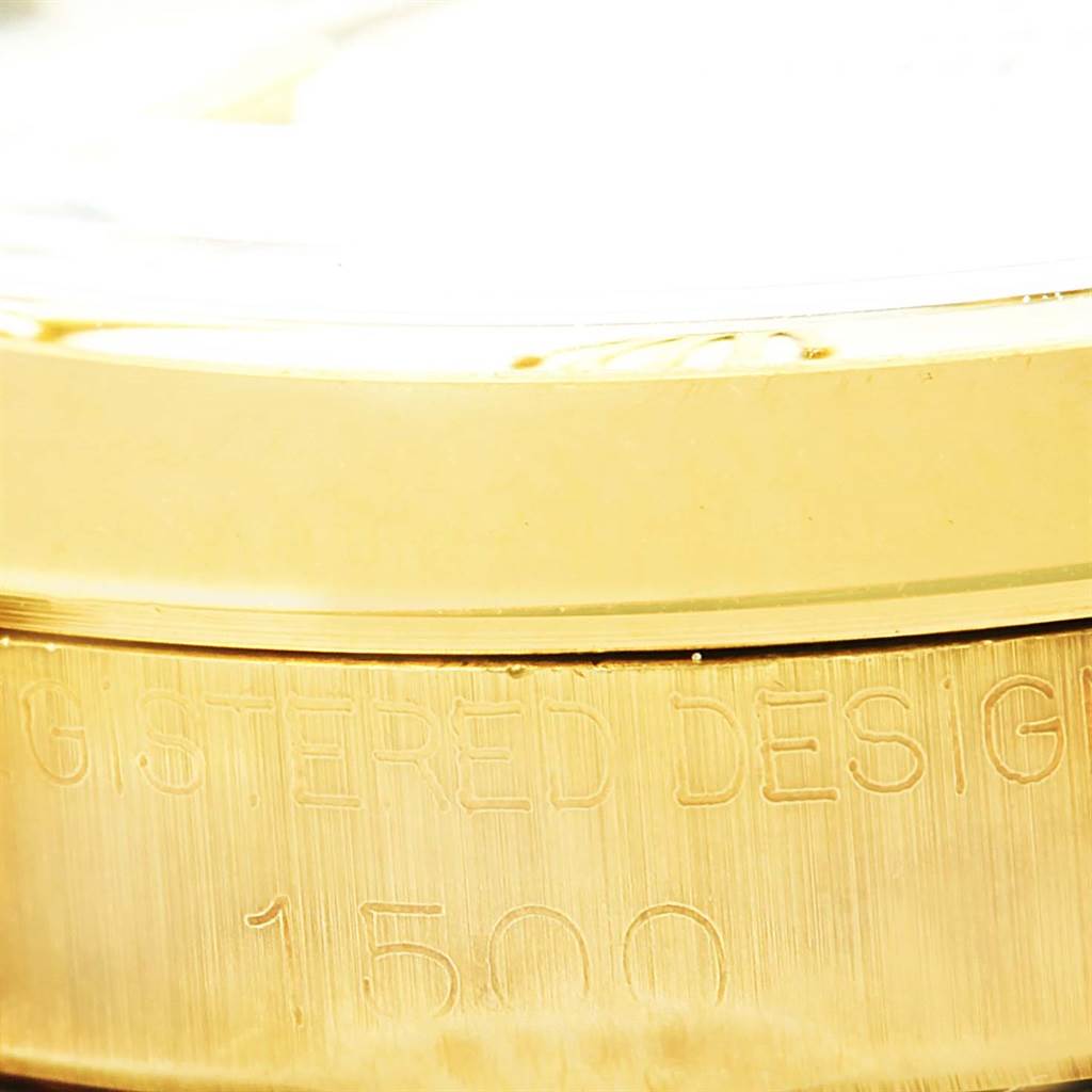 This image shows a close-up view of the casing edge of a Rolex Vintage Collection 1500 Men's Yellow Gold Champagne Dial 1500 Men's Yellow Gold Champagne Dial model, highlighting the "REGISTERED DESIGN 1500" engraving.