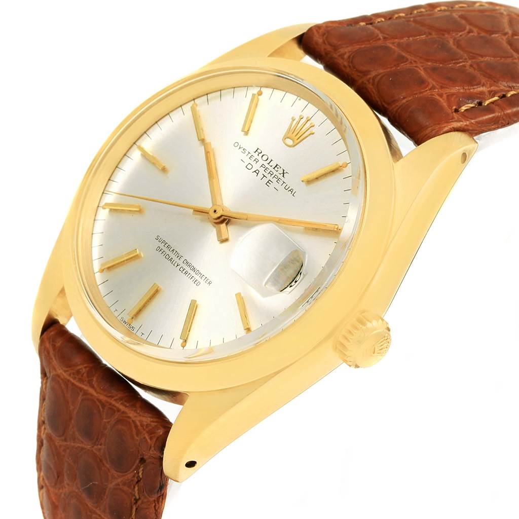 The image shows a Rolex Vintage Collection 1500 Men's Yellow Gold Champagne Dial 1500 Men's Yellow Gold Champagne Dial model from a slightly angled perspective, highlighting its gold case, silver dial, and brown leather strap.