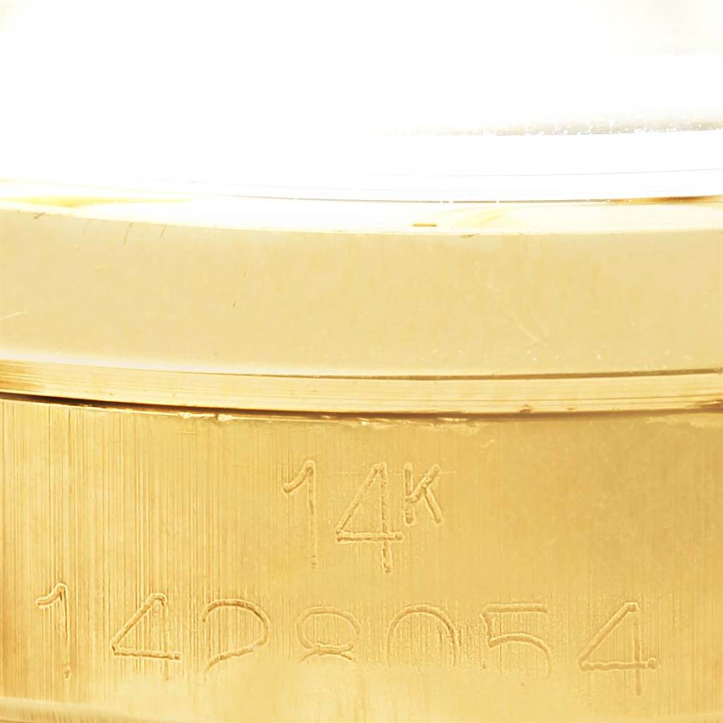 This image shows a close-up of the side of a Vintage Collection model by Rolex, highlighting the 14K gold marking and partial serial number.