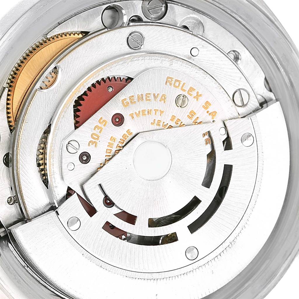 This image shows the intricate inner mechanical workings of a Rolex Vintage Collection 16014 Men's Stainless Steel Silver Dial 16014 Men's Stainless Steel Silver Dial watch, showcasing gears and the rotor.