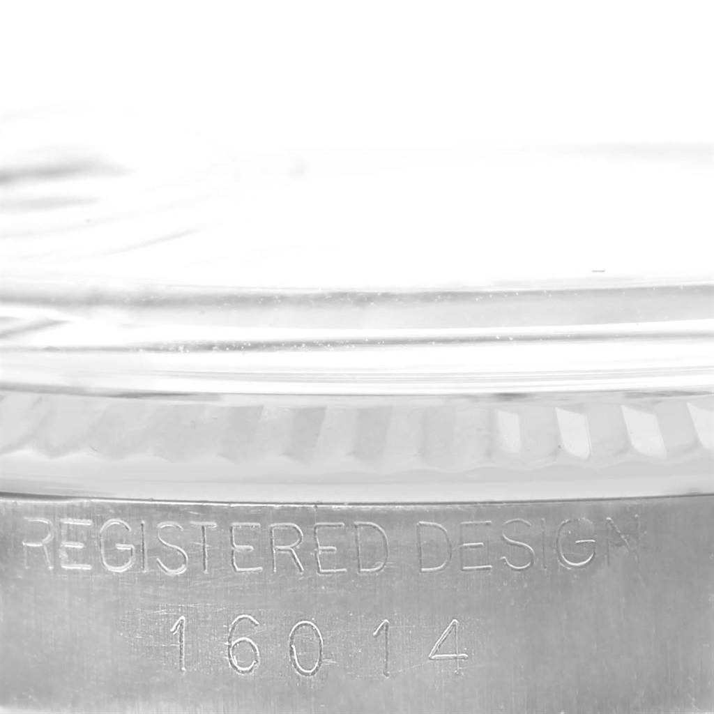 This close-up image of the Rolex Vintage Collection 16014 Men's Stainless Steel Silver Dial 16014 Men's Stainless Steel Silver Dial model shows the engraved "Registered Design 16014" on the side of the watch case.