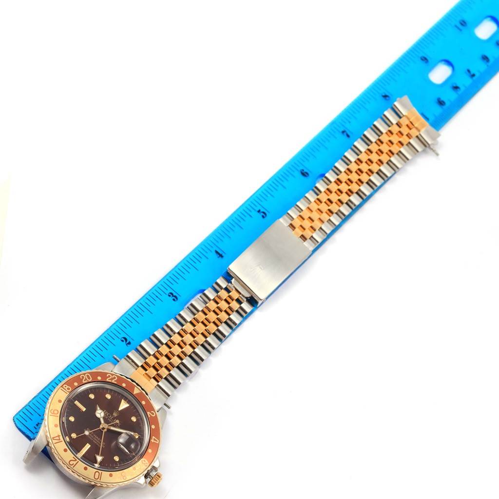 The image shows a Rolex Vintage Collection 16753 Men's Stainless Steel Brown Dial 16753 Men's Stainless Steel Brown Dial watch laid flat along a ruler, highlighting the dial and the two-tone bracelet.