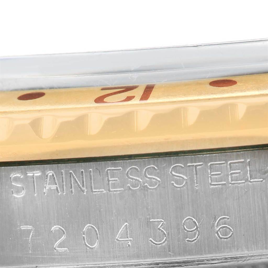 The image shows a close-up of the case side and partially exposed bezel with the "12" marker of a Rolex Vintage Collection 16753 Men's Stainless Steel Brown Dial 16753 Men's Stainless Steel Brown Dial model watch.