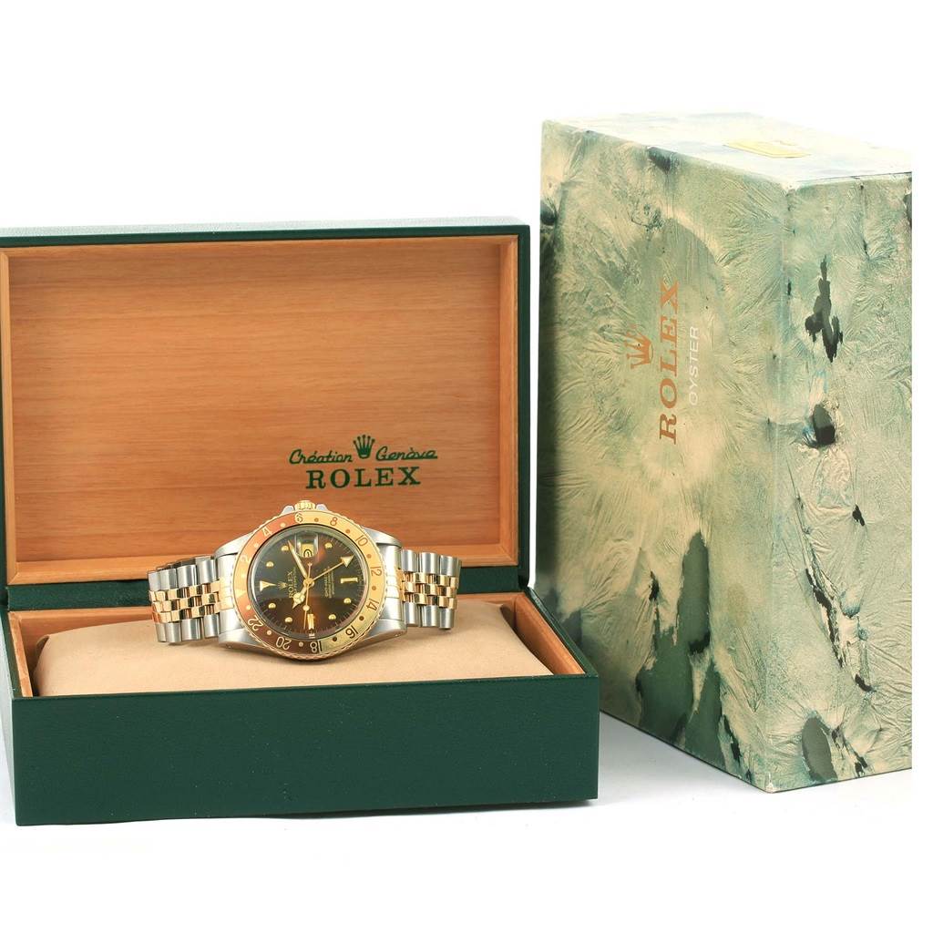 The Rolex Vintage Collection 16753 Men's Stainless Steel Brown Dial 16753 Men's Stainless Steel Brown Dial model is shown front-facing, placed inside its open box with an outer box positioned next to it.