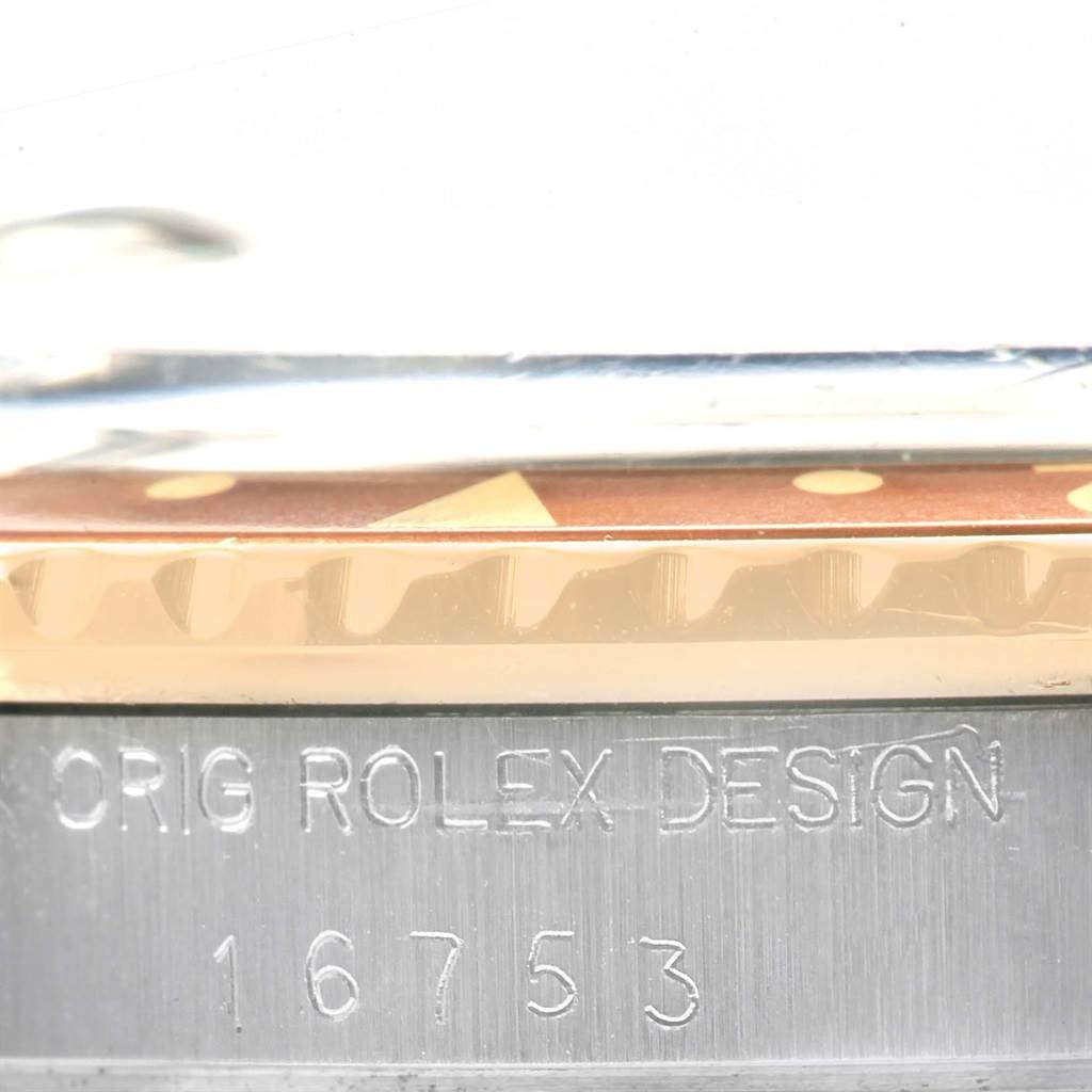 The image shows a close-up side view of the Rolex Vintage Collection 16753 Men's Stainless Steel Brown Dial 16753 Men's Stainless Steel Brown Dial model, focusing on the bezel and engravings on the case.