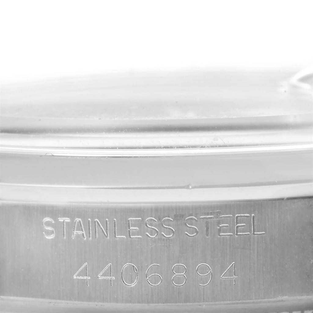 This image shows a close-up of the side of the case back and serial number of a Rolex Vintage Collection 1500 Men's Stainless Steel Silver Dial 1500 Men's Stainless Steel Silver Dial model watch.
