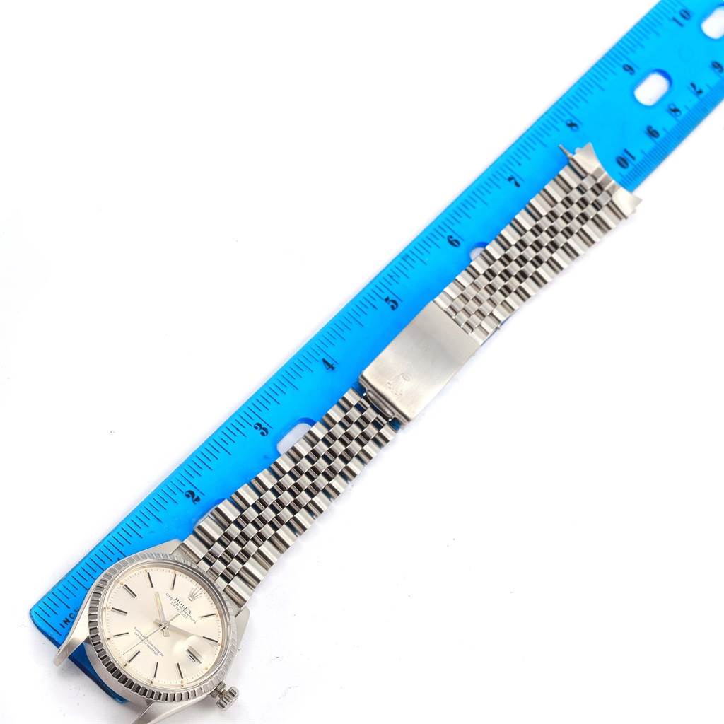 The image shows a Rolex Vintage Collection 1603 Men's Stainless Steel Silver Dial 1603 Men's Stainless Steel Silver Dial watch laid flat with its bracelet extended next to a ruler for measurement.