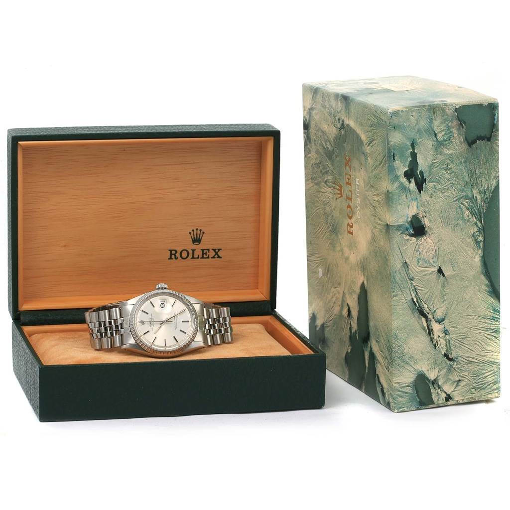 The Rolex Vintage Collection 1603 Men's Stainless Steel Silver Dial 1603 Men's Stainless Steel Silver Dial watch is displayed in an open green box with the cover placed beside it.