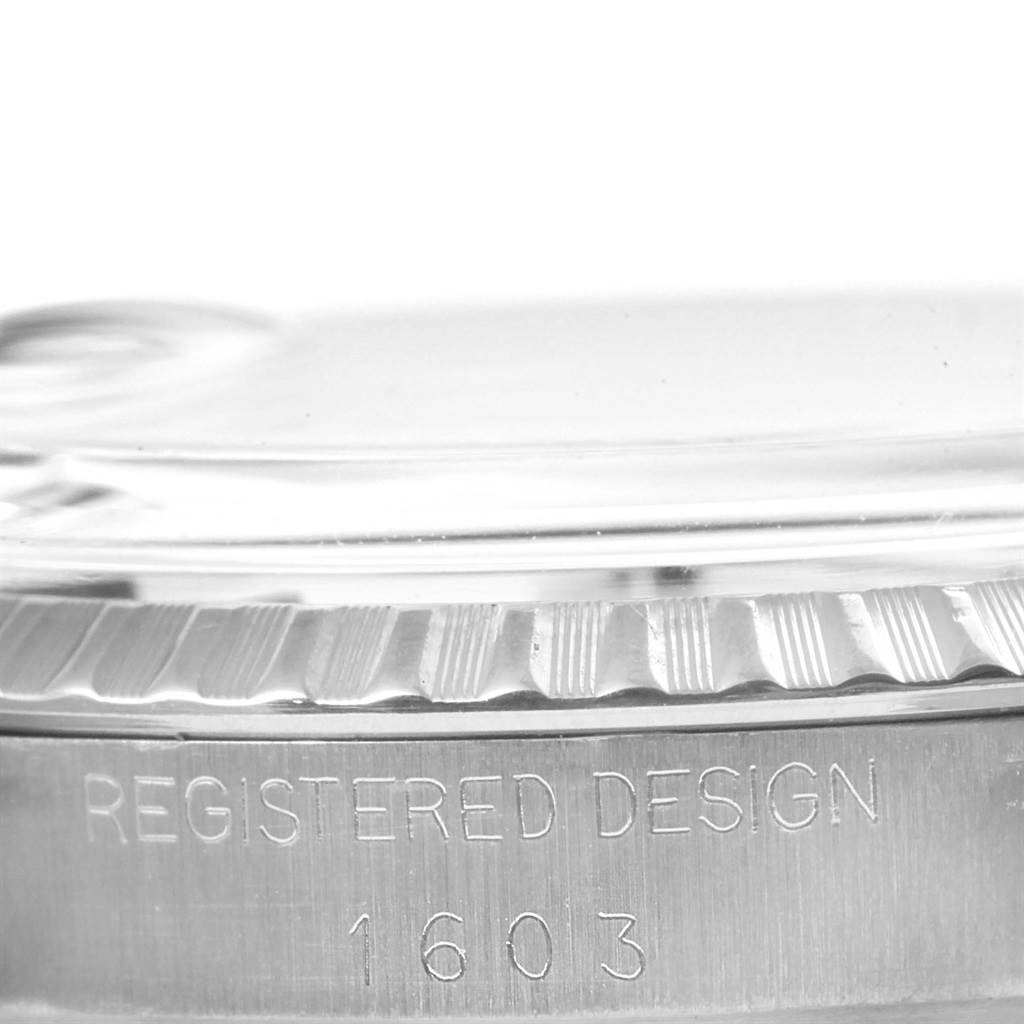 This image shows a close-up of the side of a Rolex Vintage Collection 1603 Men's Stainless Steel Silver Dial 1603 Men's Stainless Steel Silver Dial model, specifically detailing the case edge and engraved model number 1603.