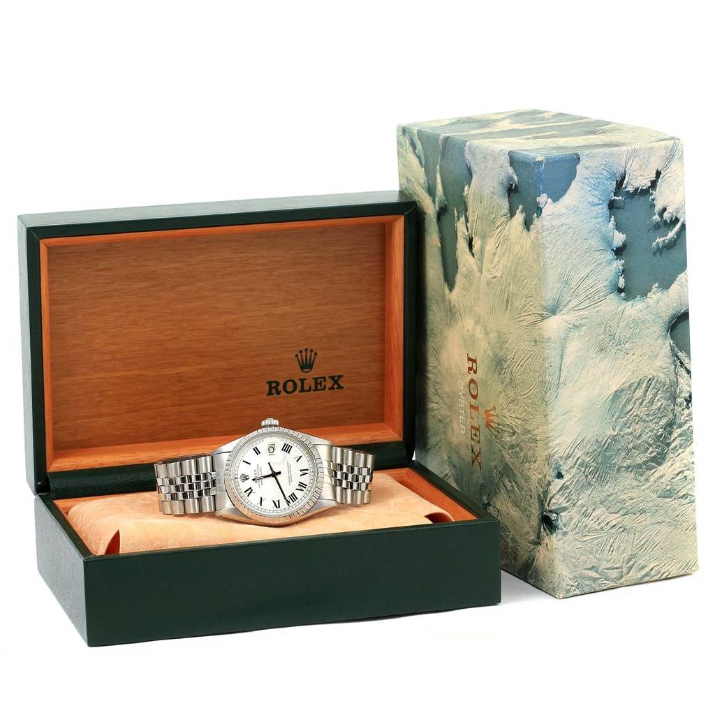 The image shows a front view of a Rolex Vintage Collection 1603 Men's Stainless Steel White Dial 1603 Men's Stainless Steel White Dial model displayed in an open green and wood watch box with a decorative outer box.