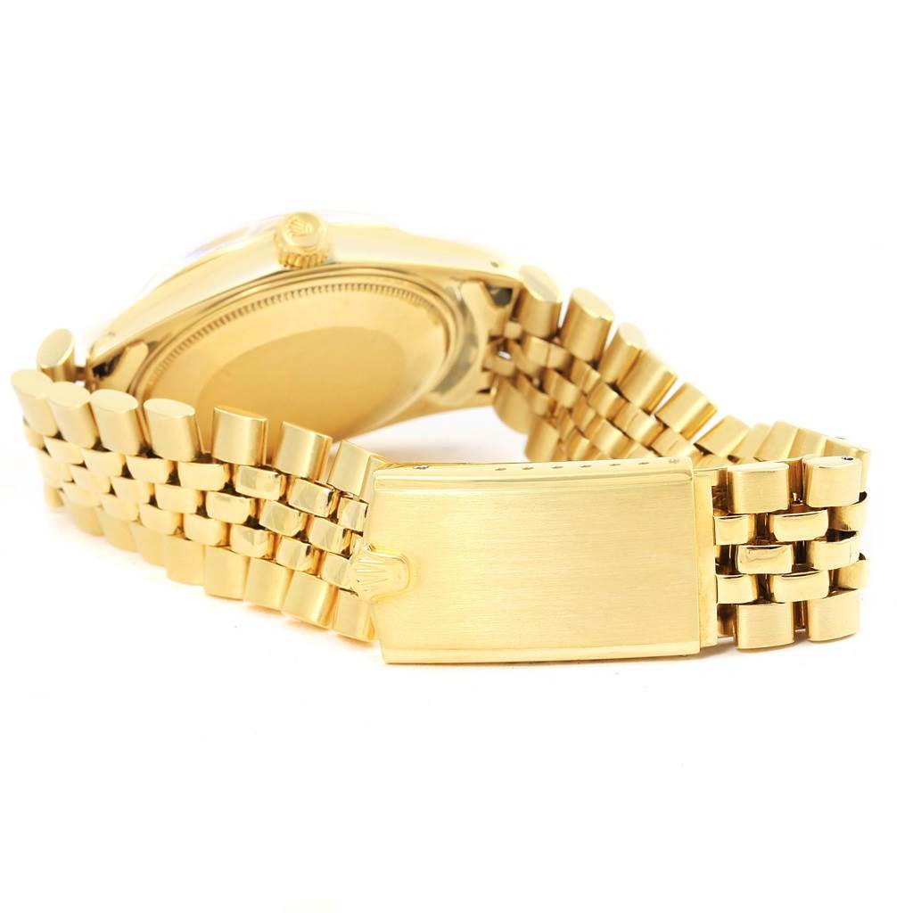 The image shows the back view of a Vintage Collection Rolex watch, highlighting its gold bracelet and clasp.