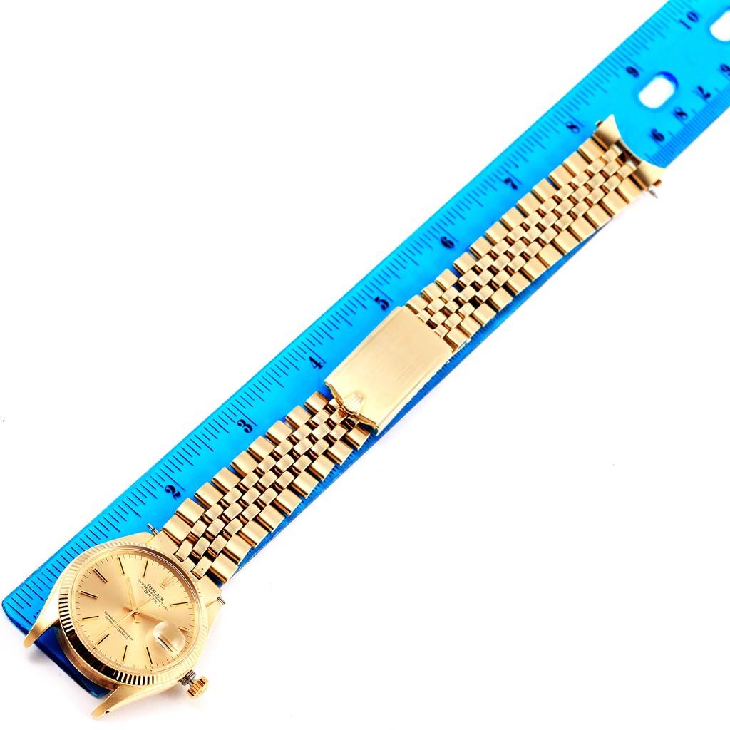 The image shows a Rolex Vintage Collection 1503 Men's Yellow Gold Champagne Dial 1503 Men's Yellow Gold Champagne Dial watch with a gold bracelet laid next to a blue ruler for measurement.