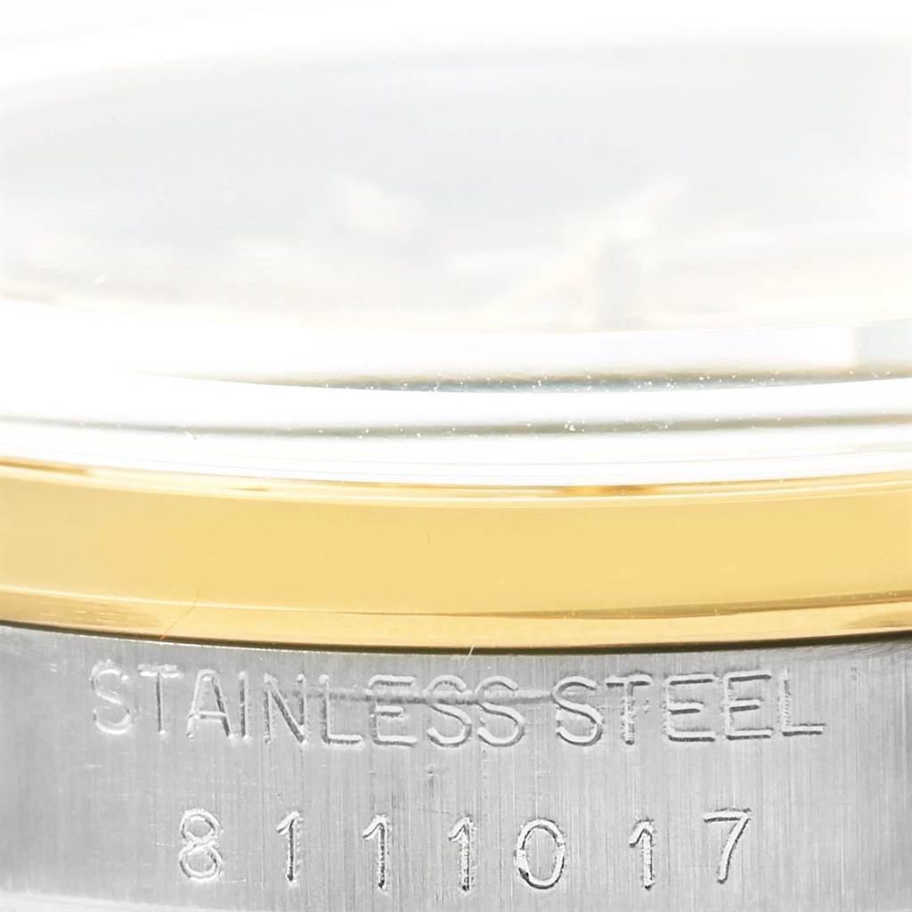 This is a close-up shot of the side of a Rolex Vintage Collection 15003 Men's Steel and Gold (two tone) Champagne Dial 15003 Men's Steel and Gold (two tone) Champagne Dial watch, showing the case with "Stainless Steel" engraving and a partial serial number.