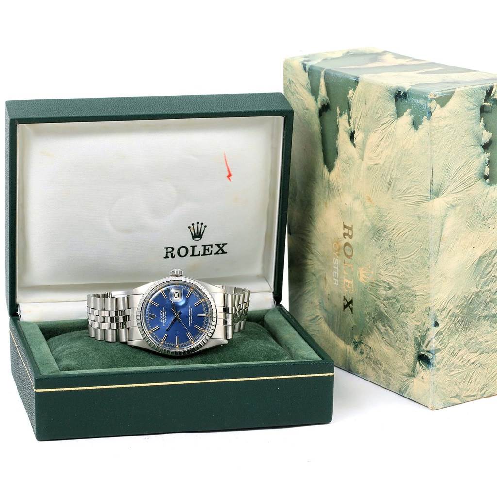 The image shows a Rolex Vintage Collection 1603 Men's Stainless Steel Blue Dial 1603 Men's Stainless Steel Blue Dial watch with a blue dial in its original box, alongside the branded outer box.
