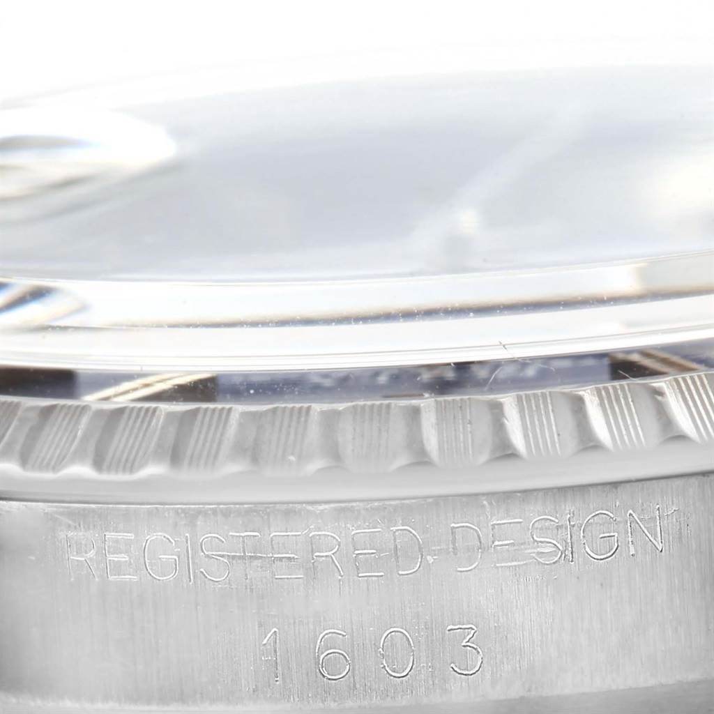 This close-up image focuses on the side engraving and fluted bezel of the Rolex Vintage Collection 1603 Men's Stainless Steel Blue Dial 1603 Men's Stainless Steel Blue Dial model 1603.