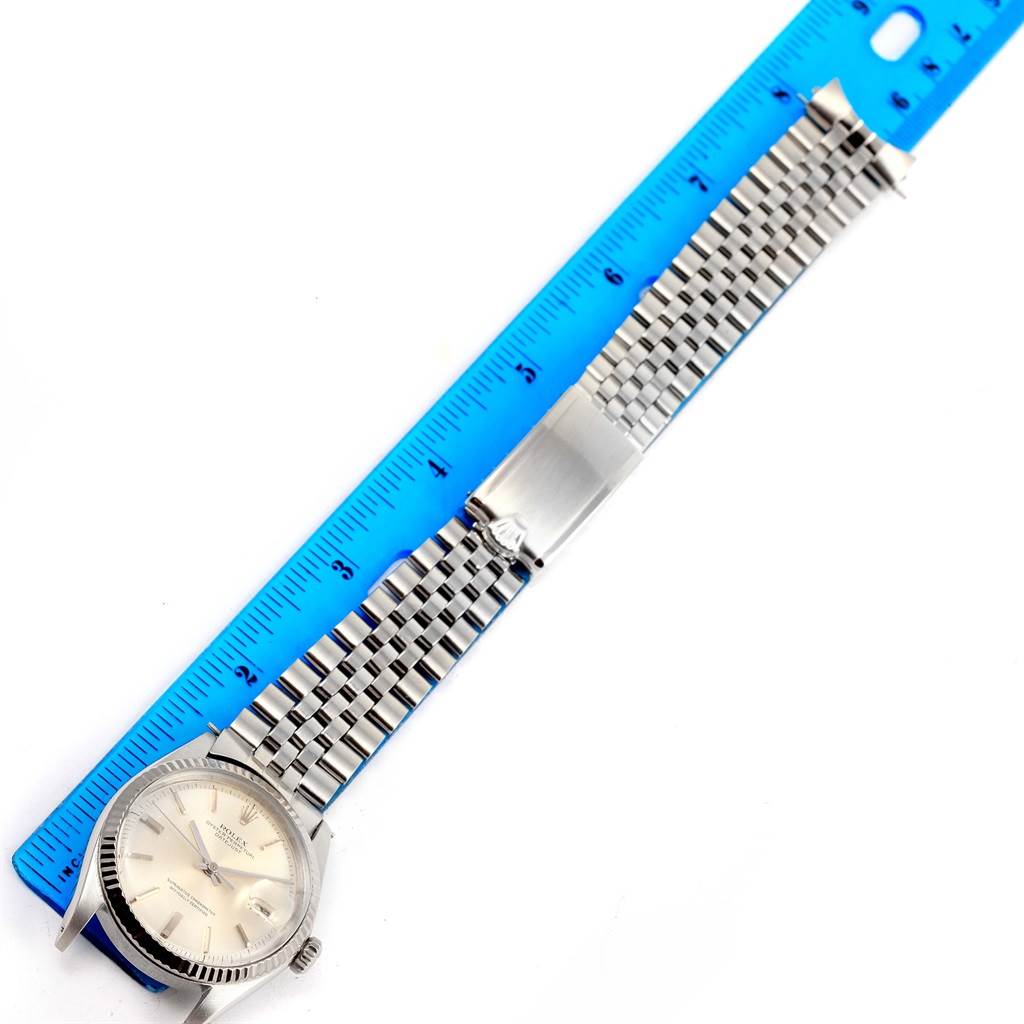 The image shows a Vintage Collection Rolex watch laid flat alongside a blue ruler, displaying the watch's face, case, and entire band.