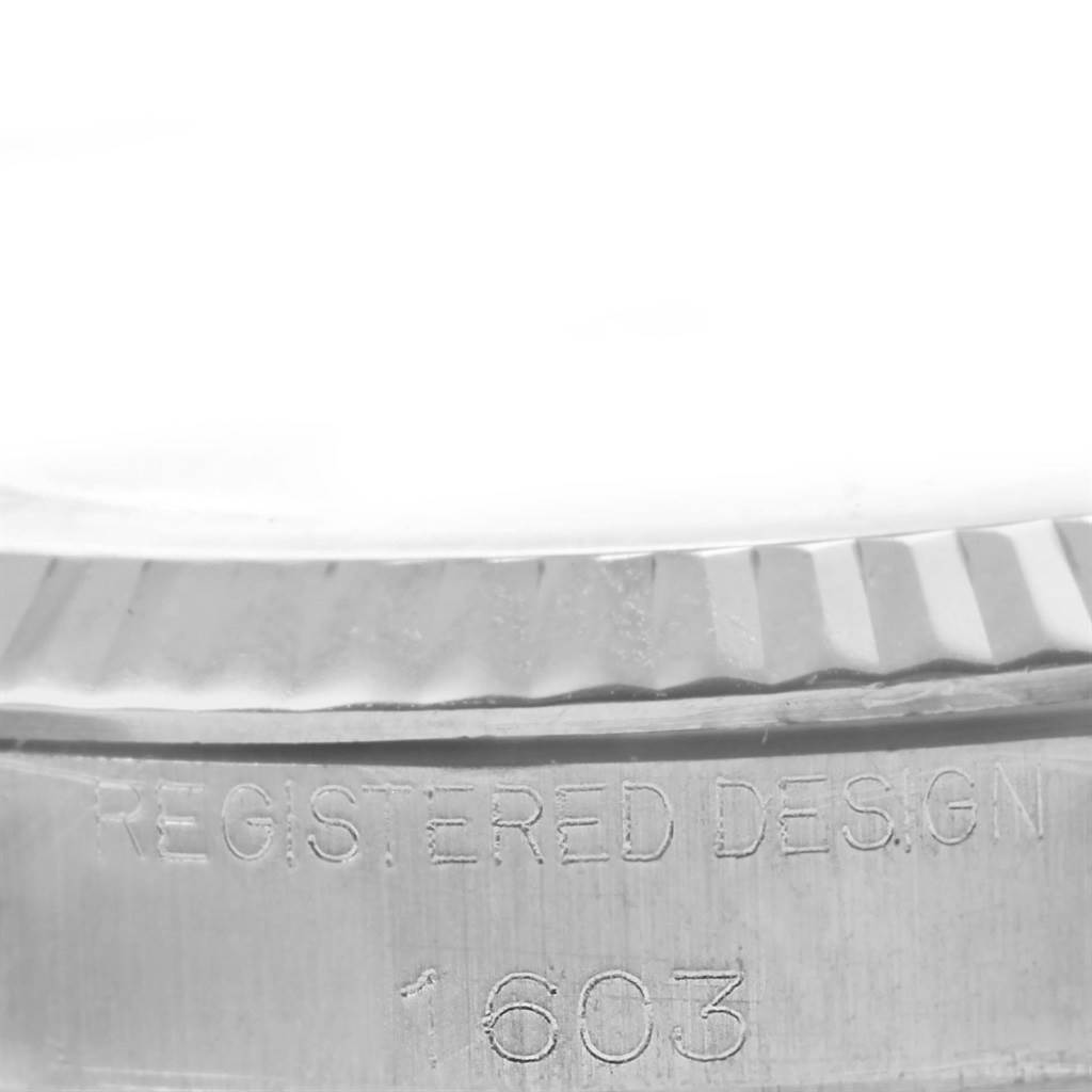 This image shows a close-up of the side of a Rolex Vintage Collection 1603 Stainless Steel Silver Dial 1603 Stainless Steel Silver Dial watch with the registered design number 1603.