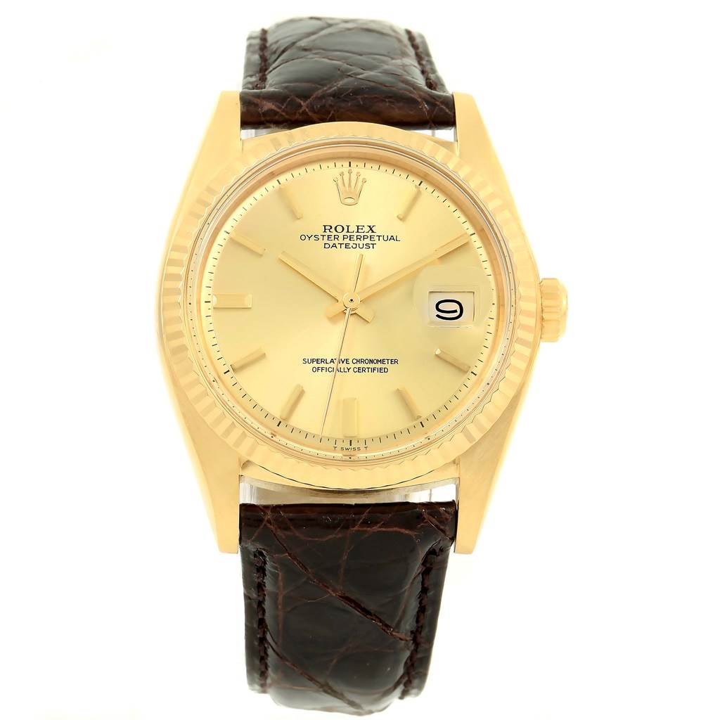 The image shows a front view of a Rolex Vintage Collection 1601 Men's Yellow Gold Champagne Dial 1601 Men's Yellow Gold Champagne Dial Oyster Perpetual Datejust watch with a gold dial and brown leather strap.