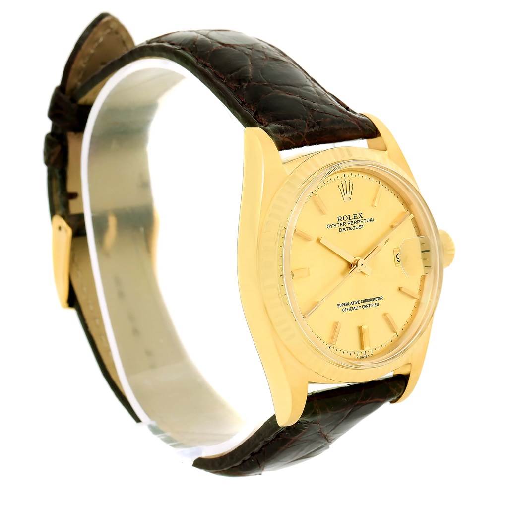 This image shows a side view of the Vintage Collection Rolex watch, highlighting its yellow gold case, brown leather strap, and dial with date display.