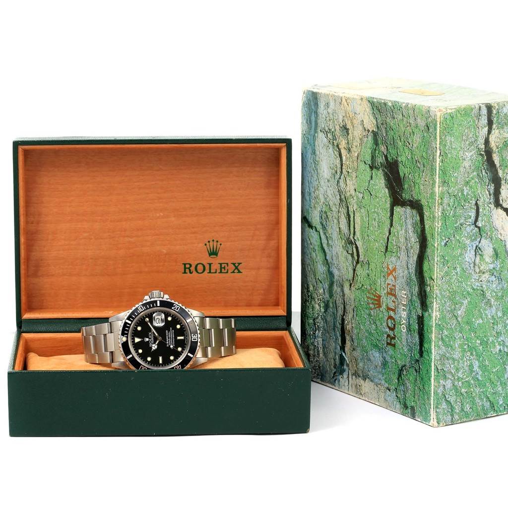 The Rolex Vintage Collection 16800 Men's Stainless Steel Black Dial 16800 Men's Stainless Steel Black Dial watch is shown front-facing in its open box with an outer green box beside it.