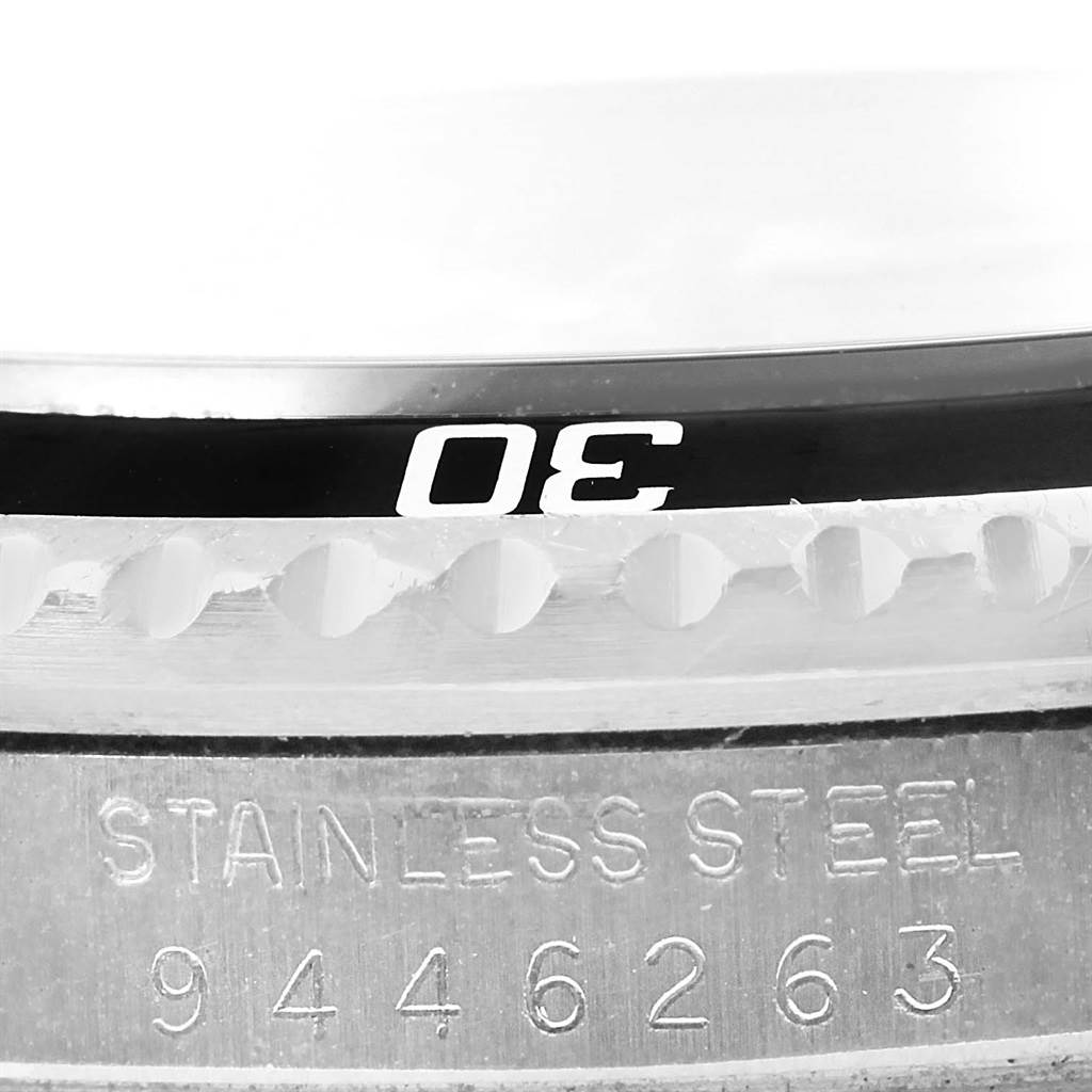 This image shows a close-up of the bezel and engraved casing of a Rolex Vintage Collection 16800 Men's Stainless Steel Black Dial 16800 Men's Stainless Steel Black Dial watch, highlighting the "30" mark and stainless steel material.