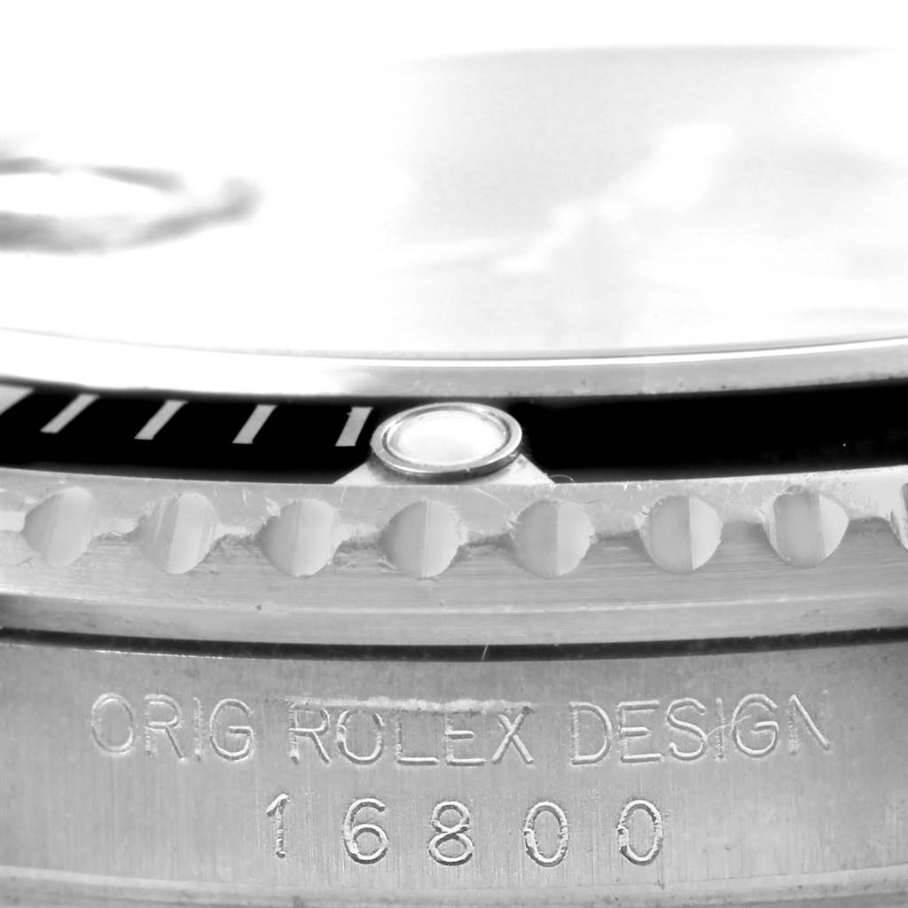 This image shows a close-up of the bezel, crystal, and engraved model number 16800 on a Vintage Collection Rolex watch.