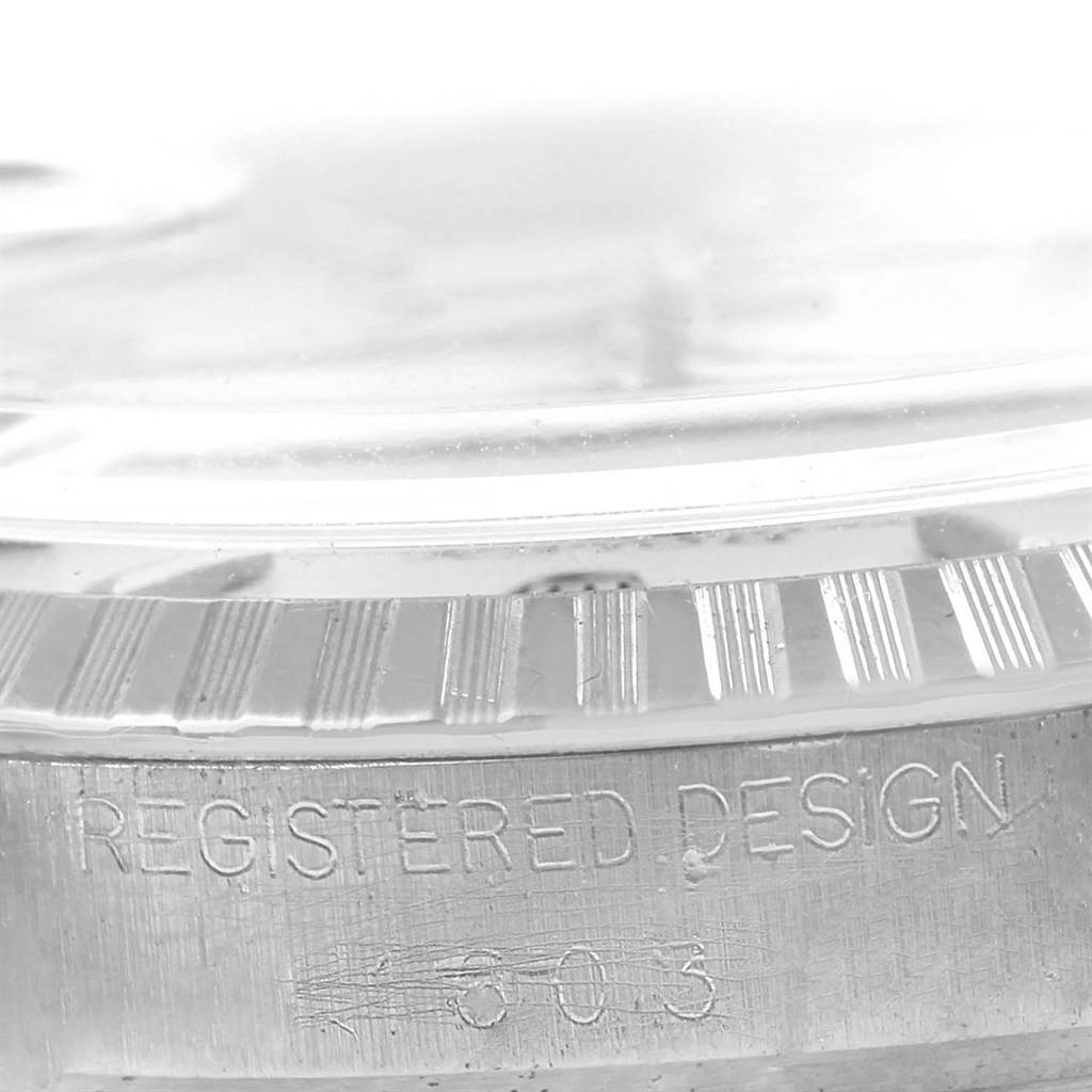 This image shows a close-up of the bezel and case side of a Rolex Vintage Collection 1603 Men's Stainless Steel Silver Dial 1603 Men's Stainless Steel Silver Dial watch, displaying the "Registered Design" engraving.