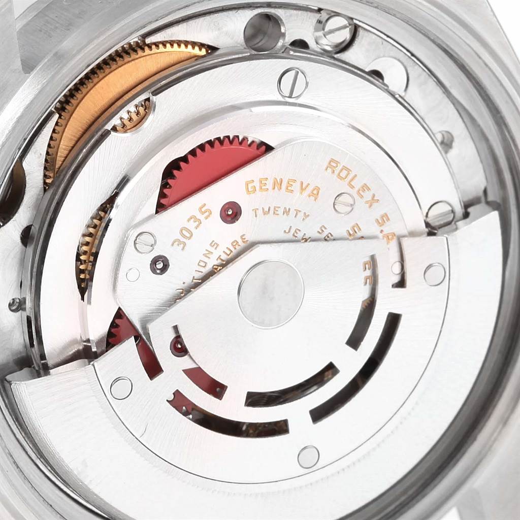 This image shows a close-up view of the internal mechanism of a Vintage Collection Rolex watch, displaying gears and the rotor.