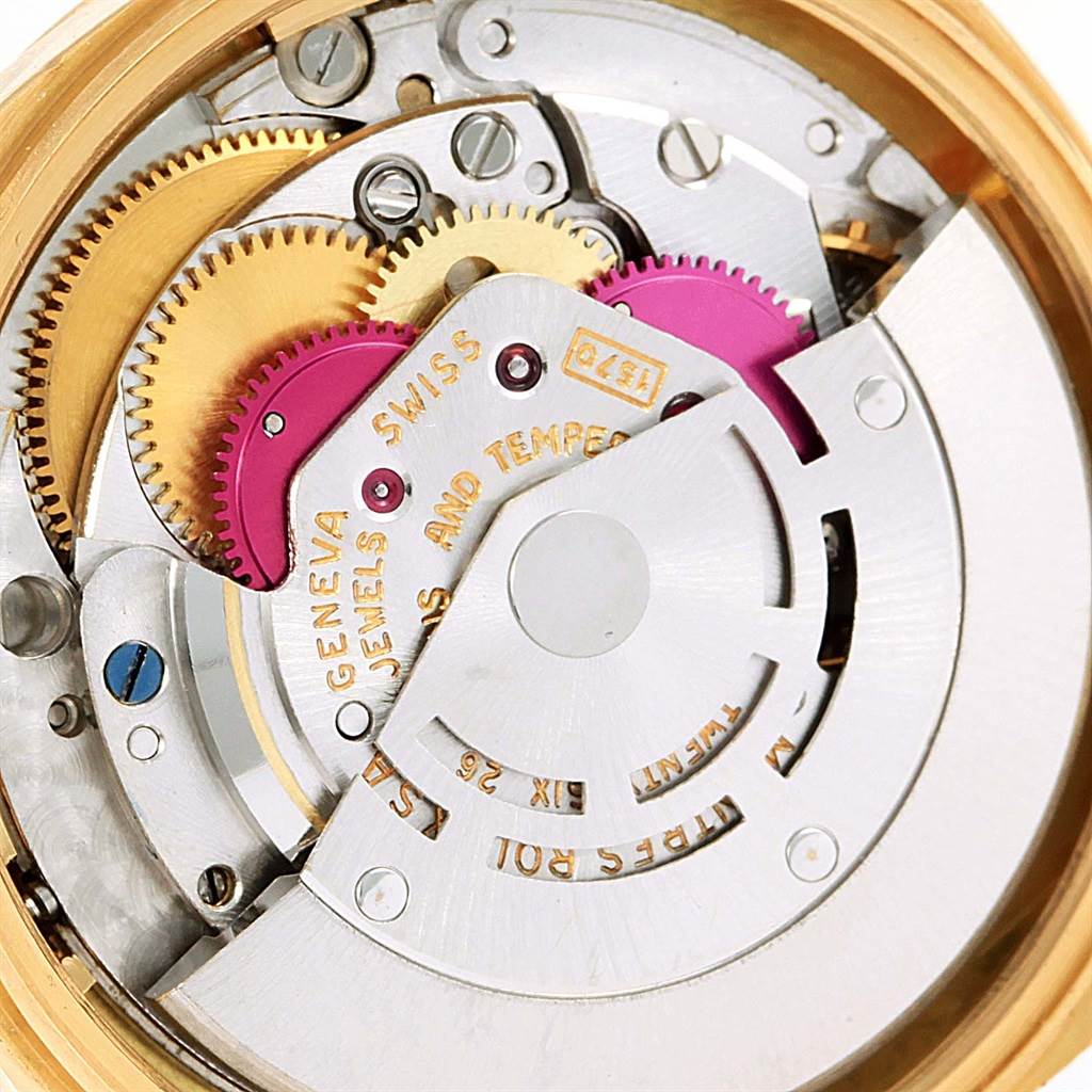 A close-up view of the internal mechanism of a Rolex Vintage Collection 1601 Men's Yellow Gold Champagne Dial 1601 Men's Yellow Gold Champagne Dial watch, showcasing gears and rotor from the back.