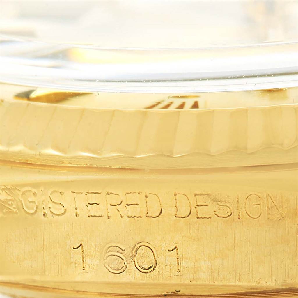 The image shows a close-up of the gold bezel and engraved model number (1601) of a Rolex Vintage Collection 1601 Men's Yellow Gold Champagne Dial 1601 Men's Yellow Gold Champagne Dial watch.