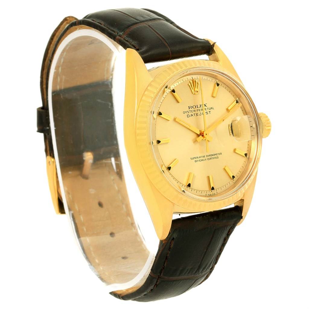 This image shows a side-angle view of a Rolex Vintage Collection 1601 Men's Yellow Gold Champagne Dial 1601 Men's Yellow Gold Champagne Dial model with a leather strap and a gold dial.