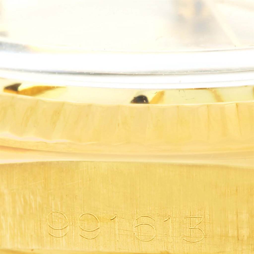 This image shows a close-up angle of the side case of the Rolex Vintage Collection 1601 Men's Yellow Gold Champagne Dial 1601 Men's Yellow Gold Champagne Dial watch, focusing on the model number "991613" engraved.