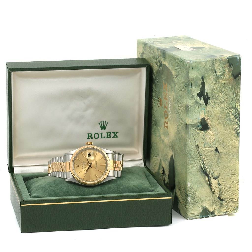 This image shows the Rolex Vintage Collection 16013 Men's Stainless Steel Champagne Dial 16013 Men's Stainless Steel Champagne Dial watch front-facing, displayed in its open green and gold box with the lid upright.