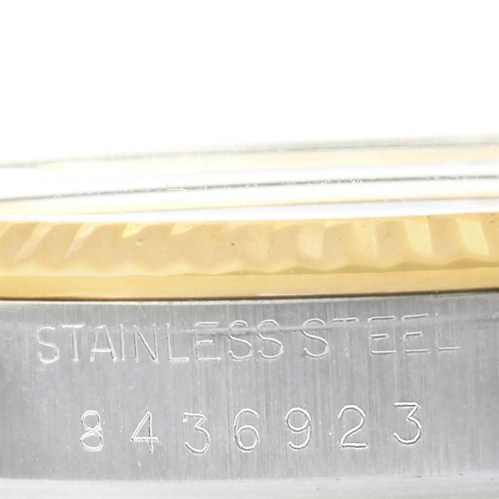 The image shows a close-up of the case side and bezel of the Rolex Vintage Collection 16013 Men's Stainless Steel Champagne Dial 16013 Men's Stainless Steel Champagne Dial watch, highlighting the serial number and "STAINLESS STEEL" engraving.