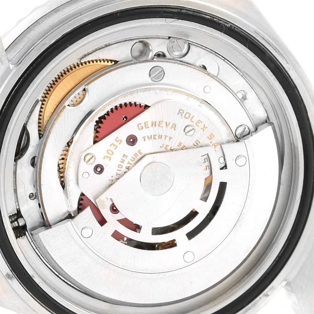 The image shows the intricate internal mechanism of a Rolex Vintage Collection 16800 Men's Stainless Steel Black Dial 16800 Men's Stainless Steel Black Dial model watch, highlighting gears and the balance wheel.