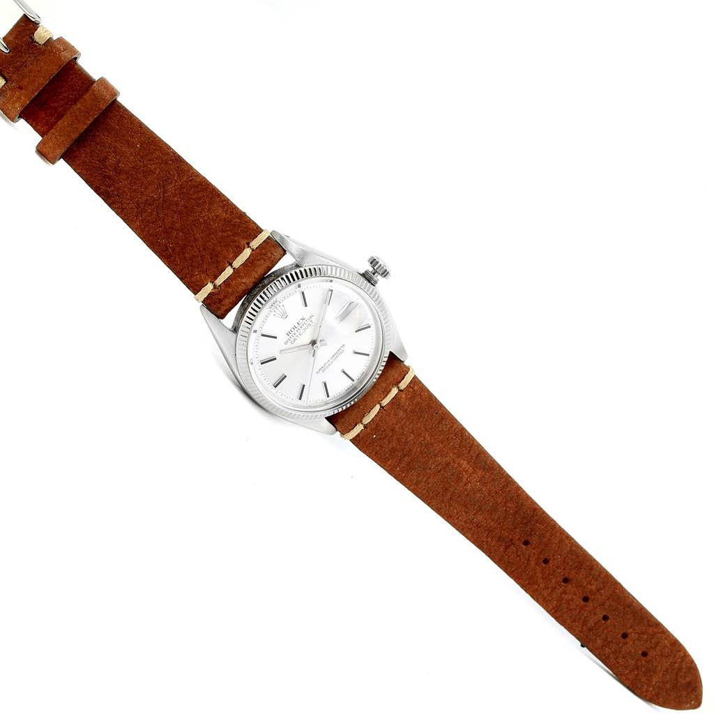 The image shows a top-down view of a Rolex Vintage Collection 16014 Men's Stainless Steel Silver Dial 16014 Men's Stainless Steel Silver Dial watch with a brown leather strap and silver dial.