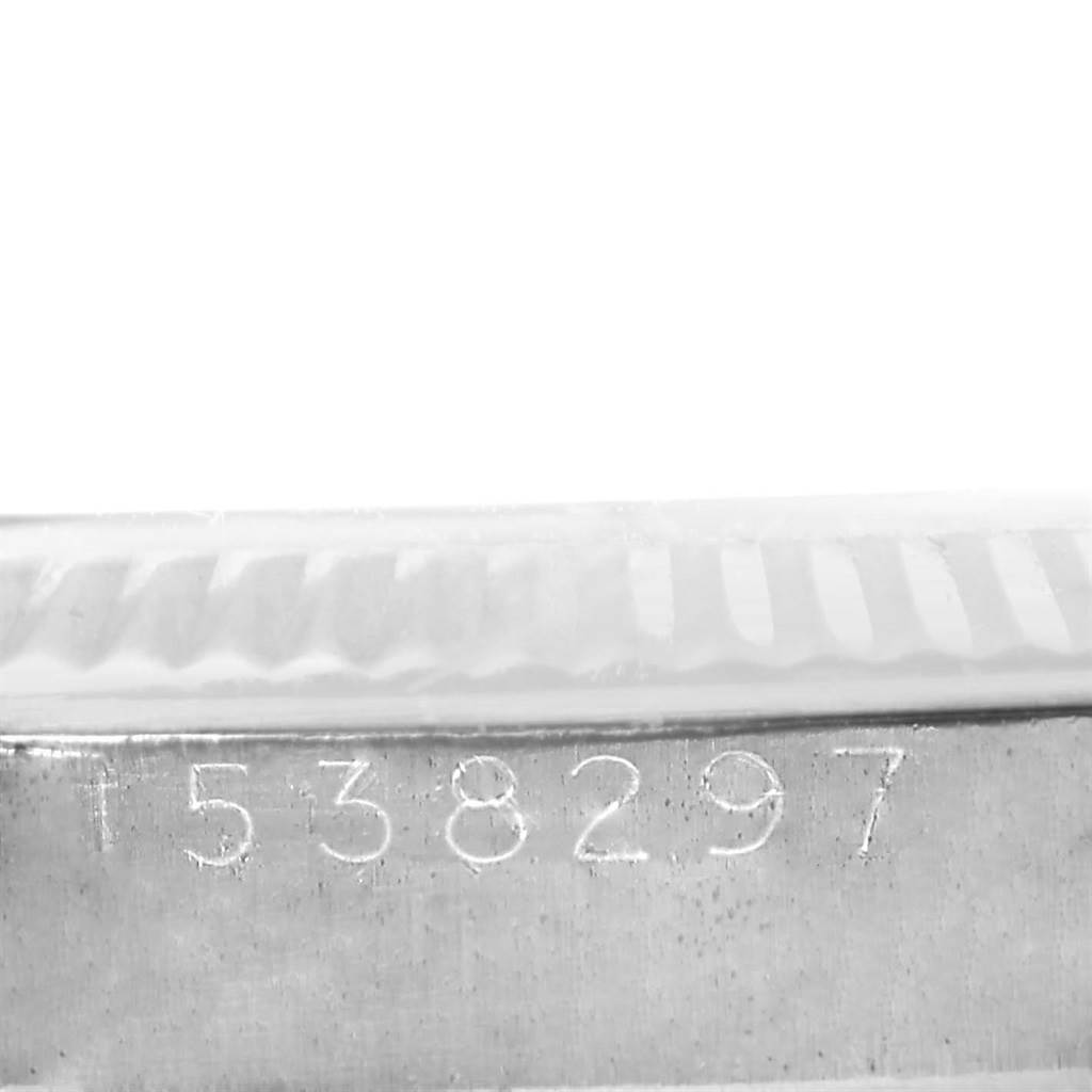 This image shows a close-up of the serial number engraving on the side of a Vintage Collection Rolex watch case.