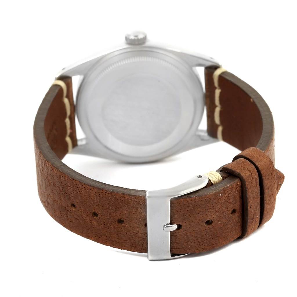 This image shows the back of the Rolex Vintage Collection 16014 Men's Stainless Steel Silver Dial 16014 Men's Stainless Steel Silver Dial watch, focusing on the case back, brown leather strap, and buckle.