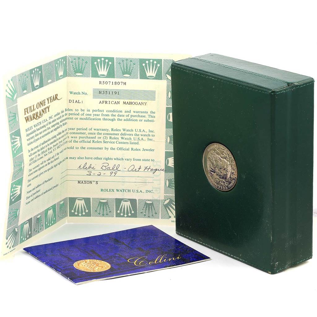 The image shows the warranty card and packaging for a Vintage Collection model by Rolex, including a green box and documentation.