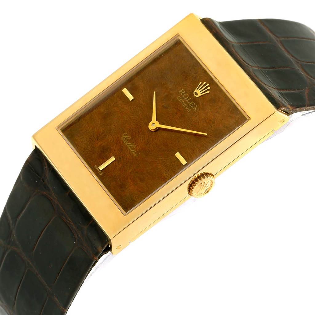 The image shows a side-angle view of the Vintage Collection model by Rolex, highlighting the watch face, gold case, dial, and black leather strap.