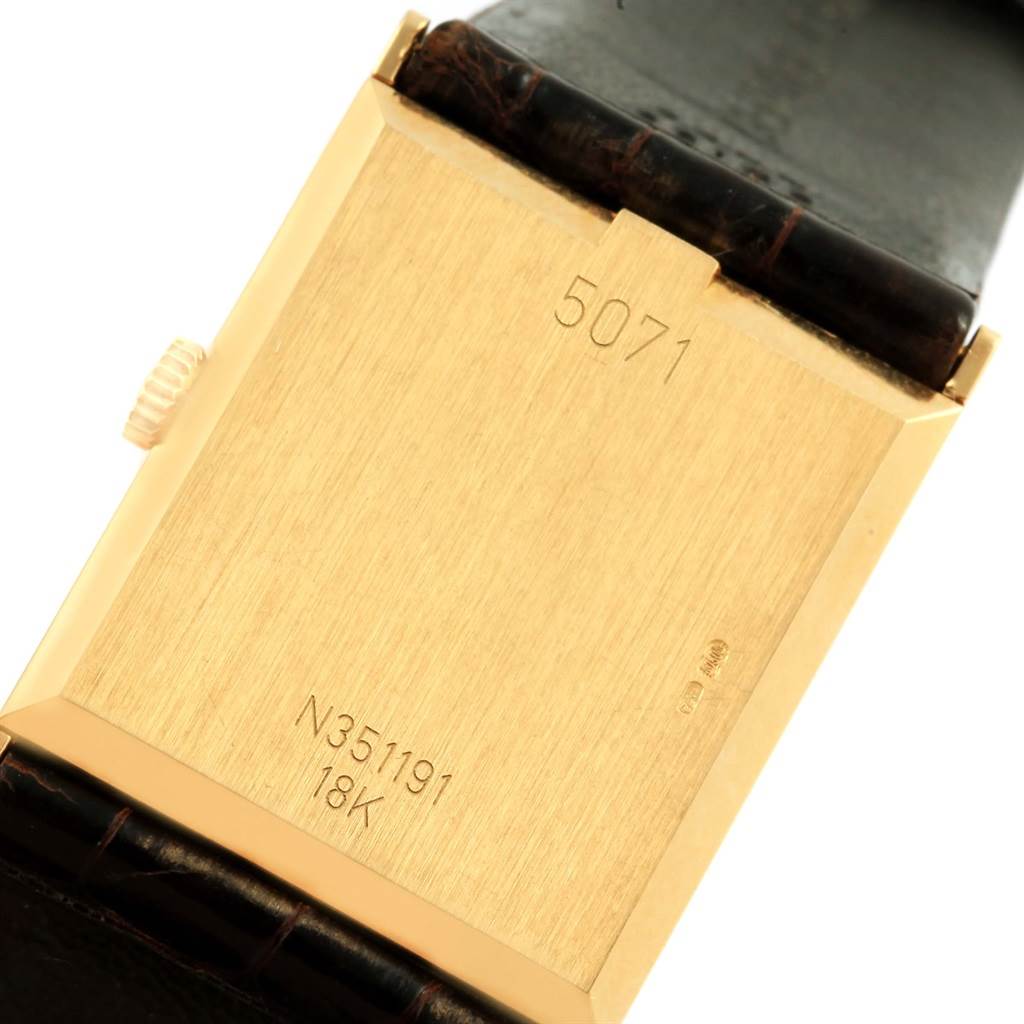 This image shows the back of a Rolex Vintage Collection 5071 Men's Yellow Gold Brown Dial 5071 Men's Yellow Gold Brown Dial watch, displaying its case, serial number, and 18K gold mark.