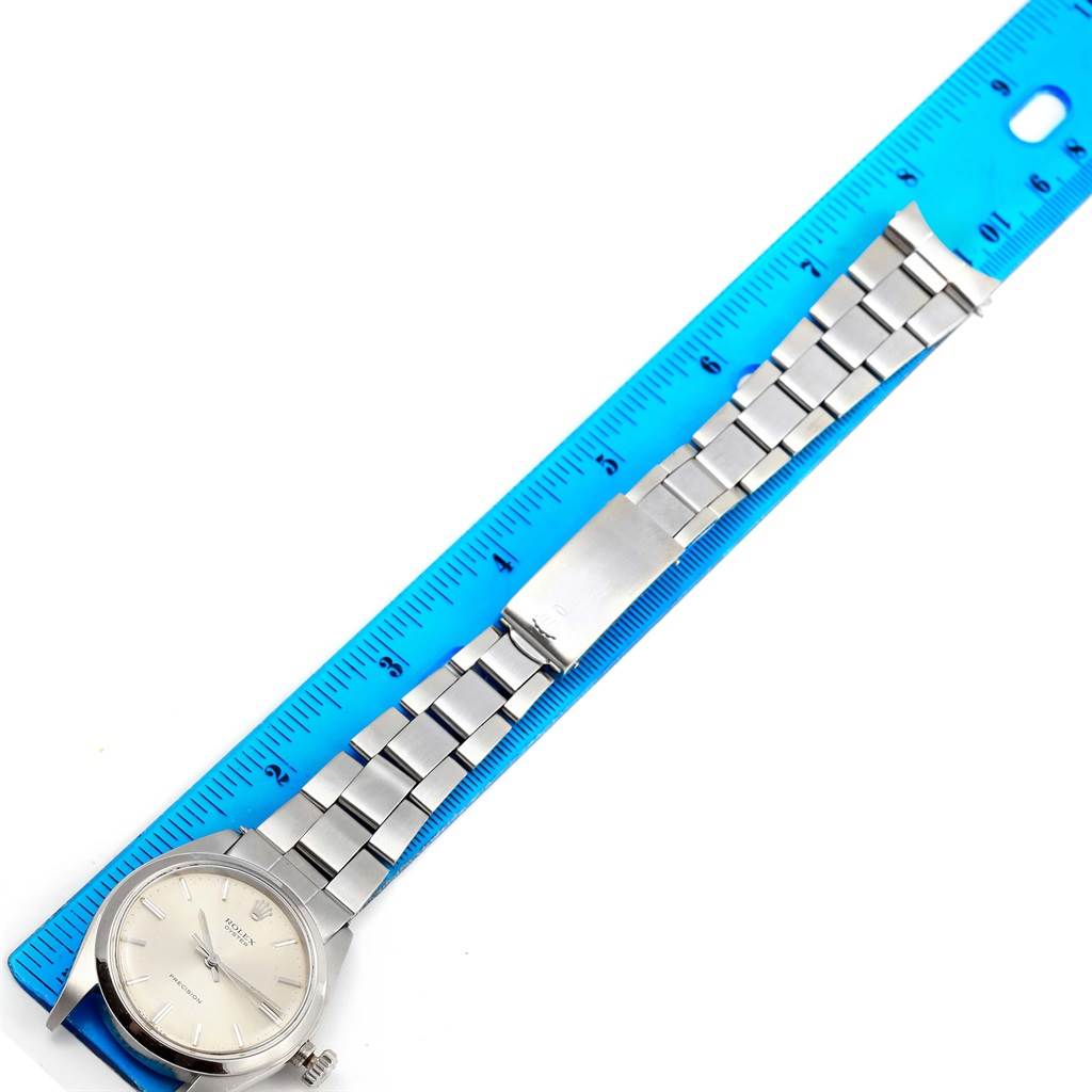 The Rolex Vintage Collection 6426 Men's Stainless Steel Silver Dial 6426 Men's Stainless Steel Silver Dial model watch is shown from a top-down angle, displaying the dial, bracelet, and clasp next to a blue ruler.