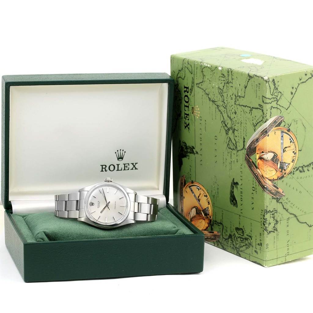 The image shows a front view of a Rolex Vintage Collection 6426 Men's Stainless Steel Silver Dial 6426 Men's Stainless Steel Silver Dial watch in its green watch box, alongside its decorative outer box.